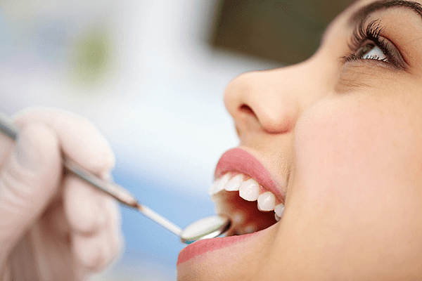 Dentist examining patients teeth